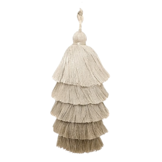 Decorative tassel with multiple layers on a white background. custom tassels are produced using low-impact processes, renewable fibers, and fair artisan labor.